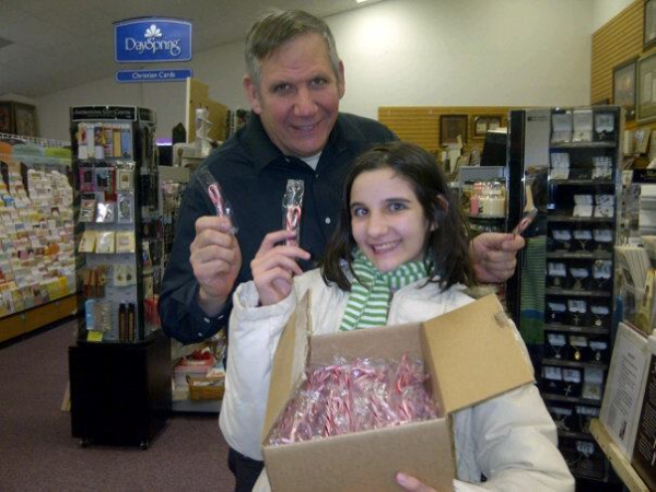 This was taken a few years ago when we were getting ready to pass out candy canes in a Christmas parade.  This box of candy canes was a special surprise gift from a friend and it still makes me smile to remember all the blessings of that year!  (Our daughter, Susanna, is helping me here.)